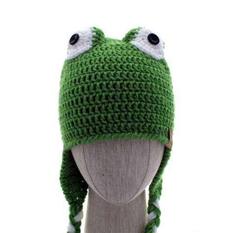Working in 3 stitches at bottom of earflap, fold two strands of yarn in half. . Frog hat crochet pattern